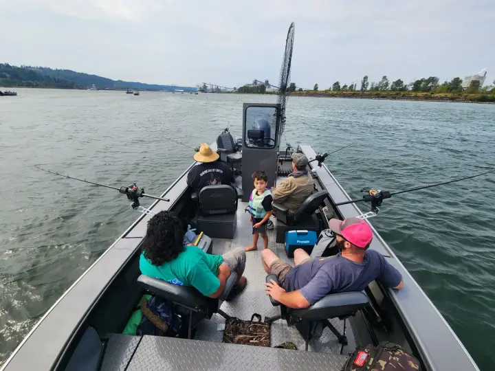 A family trolling aboard the boat with rods out