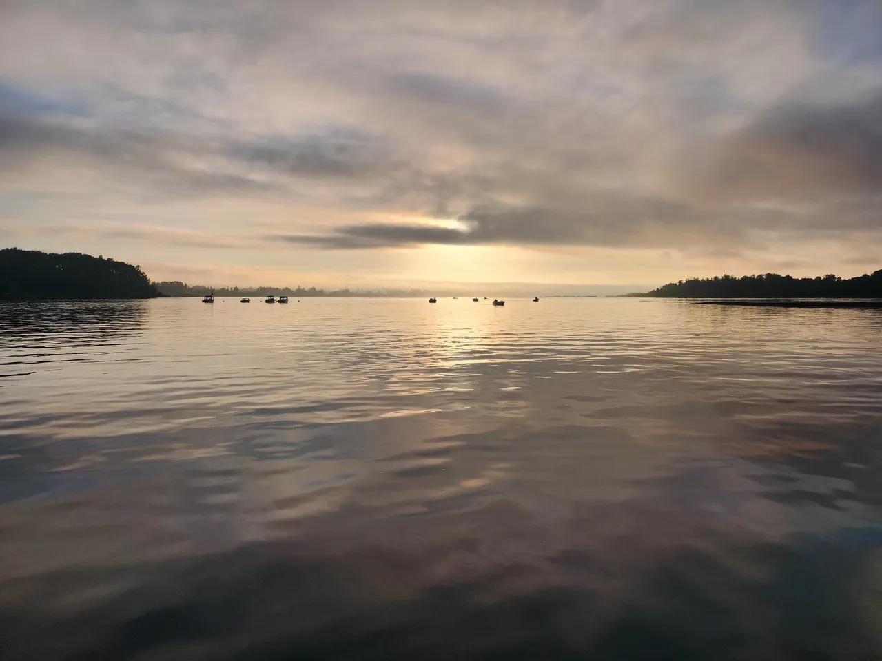 Sunrise over the Columbia River with guide boats on the water